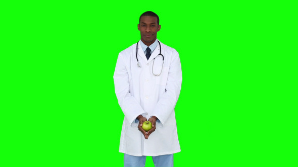 Happy Young Doctor Showing Camera An Apple 3