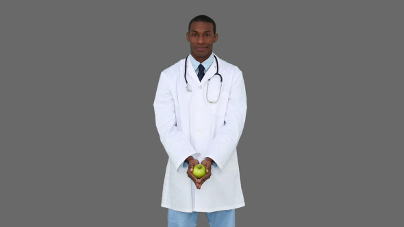 Happy Young Doctor Showing Camera An Apple 5