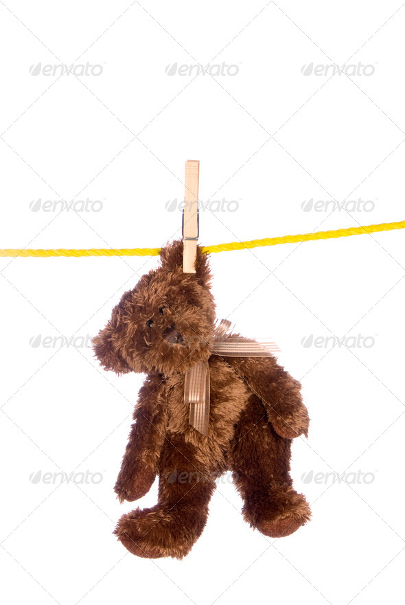 Teddy bear hanging from a clothesline - Stock Photo - Images