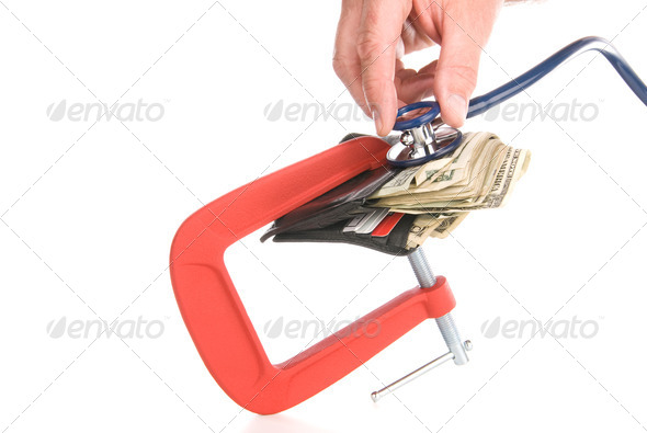 Clamped wallet examined with stethoscope - Stock Photo - Images