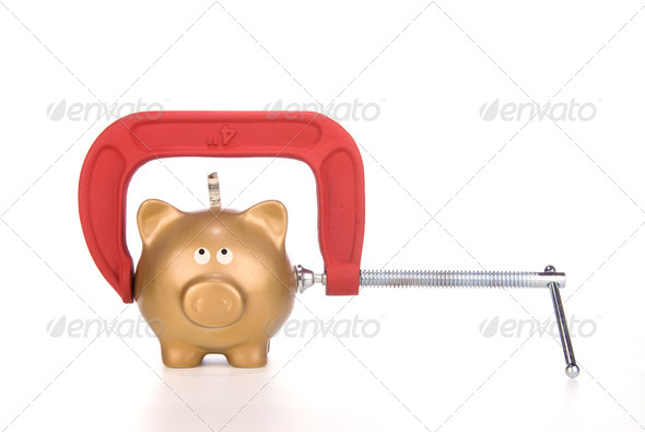 Piggy bank being squeezed - Stock Photo - Images