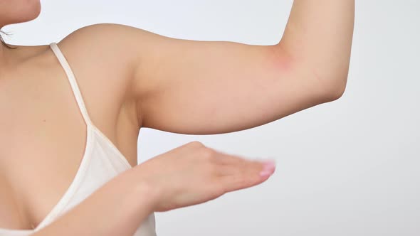 Young Woman Touching Flabby Muscles Triceps