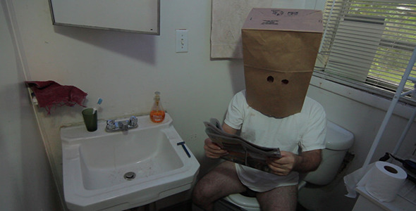 Unknown Masked Man Reads Newspaper