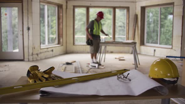 Focus on items in foreground with construction worker in background