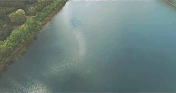 Panoramic View on Blue Water in a Forest Lake with Trees Large Panorama alt