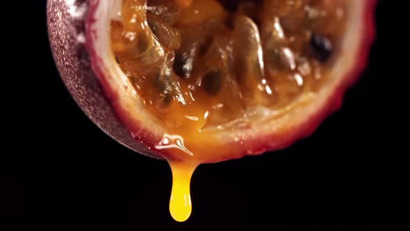Slow Motion Macro Shot of Flowing Passion Fruit Maracuya Juice From Halved Maracuya alt