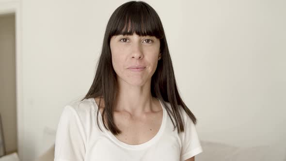 Happy Dark Haired Young Woman Posing in Home Interior alt
