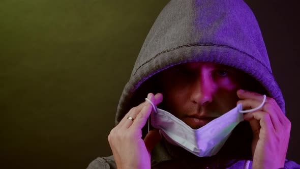 Man puts mask on during corona virus outbreak alt