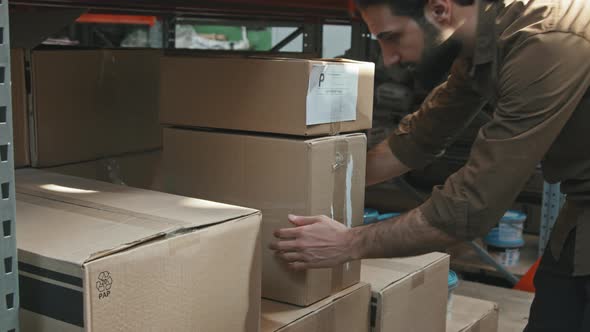 Man Moving Boxes in Warehouse alt