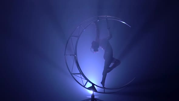 Art Acrobatics on the Design That Rotates in the Unfocus Dark Room with Blue Smoke. Blue Smoke alt