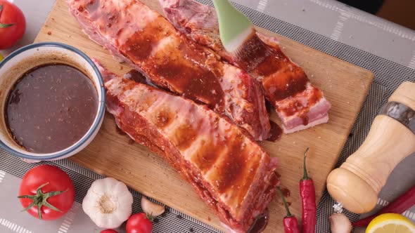 Ribs Get Glazed with Brush with Sweet Barbeque Sauce in Slow Motion Closeup alt