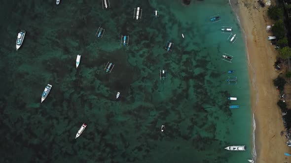 Beautiful cinematic Sanur beach, Bali drone footage with interesting landscape, fishing boats and ca alt