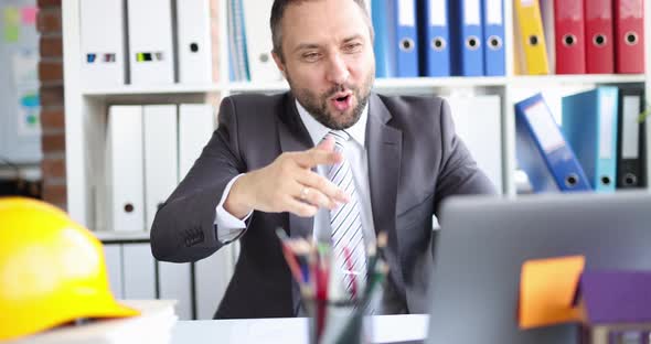 Male Contractor Builder Greets a Client on Video Call