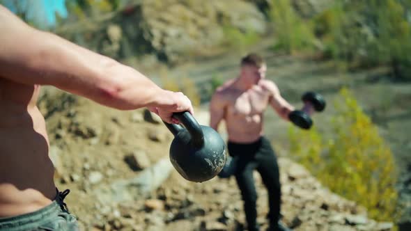 Bodybuilders training among nature. alt