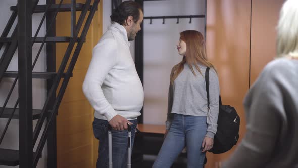 Caucasian Woman See Off Husband and Daughter for Trip. Teenage Girl and Adult Man Putting on Covid alt