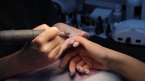 Anonymous Beautician Doing Manicure to Female Client