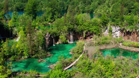 Aerial view of flowing waterfall in turquoise water lakes in Croatian national park. Summer leisure alt
