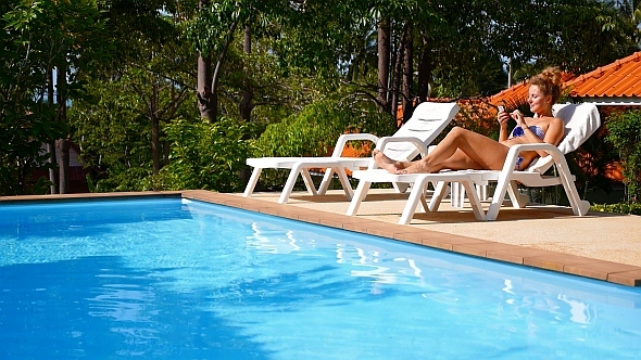 Using Smart Phone by the Poolside alt