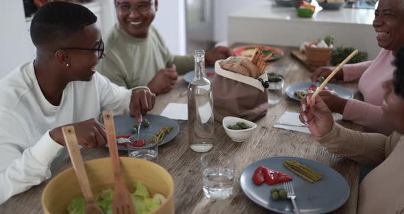 African family having fun together at lunch alt