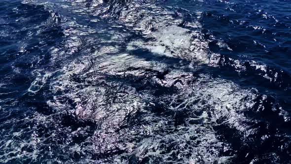 Ocean waves as the sun reflects on the frothy rolling waters Segment 2 of 2 alt