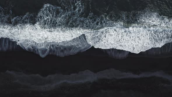 White Surf Washing Over Black Sand alt