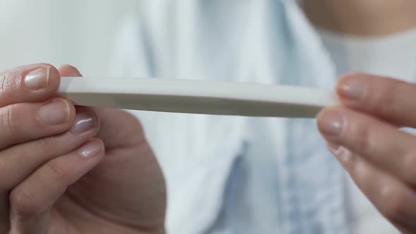 Woman Fingers Holding Pregnancy Test, Turning It to Show One Line, Infertility alt