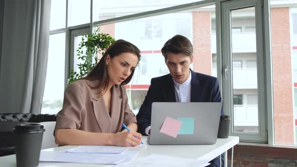 Man and woman work in comfortable modern office with laptop. Working process alt