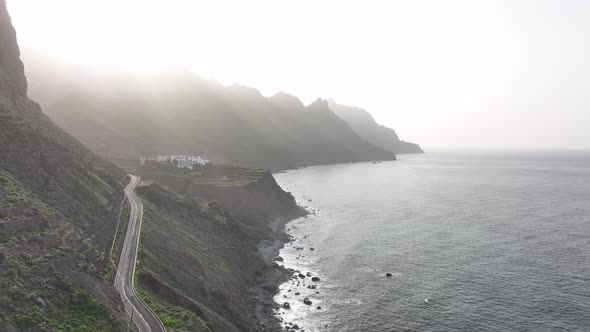 Rocky Volcanic Beach Surrounded By High Mountains and Cliffs Aerial Drone View alt
