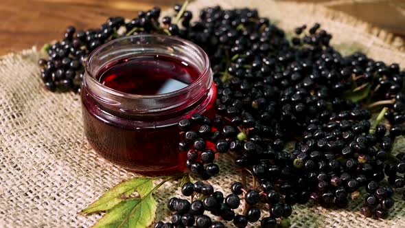 Natural Elderberry Juice. Black Elderberry On A Wooden Background. Herbal Medicine. Homeopathy