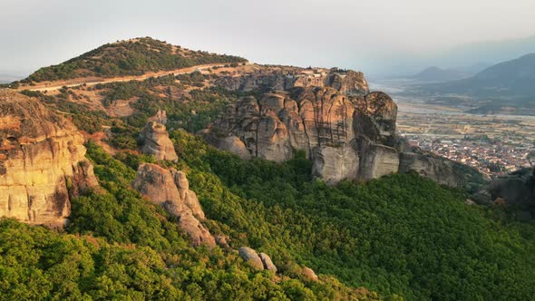 Aerial drone view of the Meteora in Greece at sunset. Rock formations with Orthodox monasteries alt