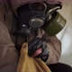 Close Up Survivor Stalker Digging in His Old Backpack in Midst of Uninhabited Abandoned Old Houses