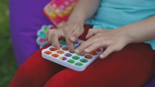 Child Hands Playing With Antistress Toys
