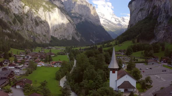 Circling around a little church in the beautiful valley of lauterbrunnen. It reveals a waterfall in alt