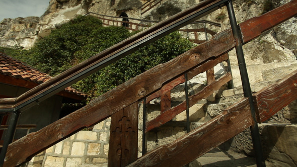 Monk Climbing Stairs To Old Church
