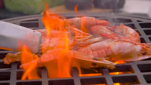 Slow Motion: Chef Grilling Red King Prawns on Brazier with Hot Flame - Close Up