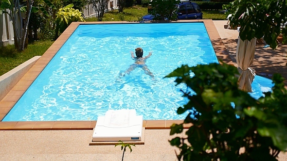 Woman Swimming in Pool in Slow Motion alt