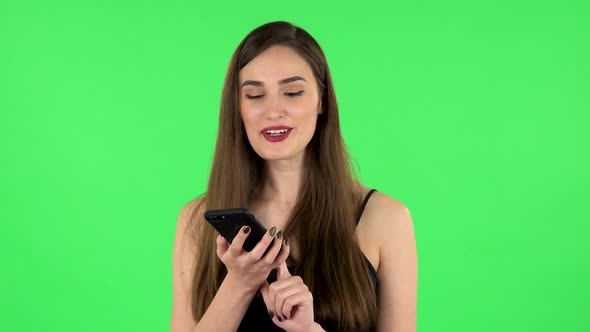 Girl Asks for Information on the Network Via Phone on Green Screen alt
