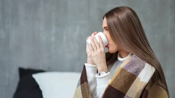 Medium Closeup Profile of Smiling Young European Girl Wrapped Warm Plaid Dreaming at Cozy Home alt