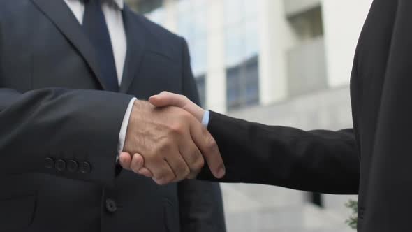 Male and Female Business Partners Shaking Hands Outdoor, Successful Deal Closeup