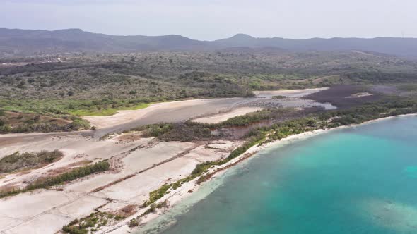 Turquoise Blue Water With Sweeping Forest Landscape At Playa La Ensenada At Summer In Dominican Repu alt