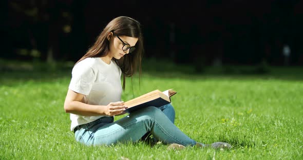 Woman Reading Book in Park