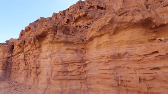 Orange rocky dunes in Egypt Canyon site with a panning camera move from right to left showing the ar alt