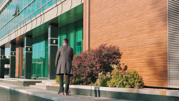 Walking On E-Scooter On Sunny Day alt