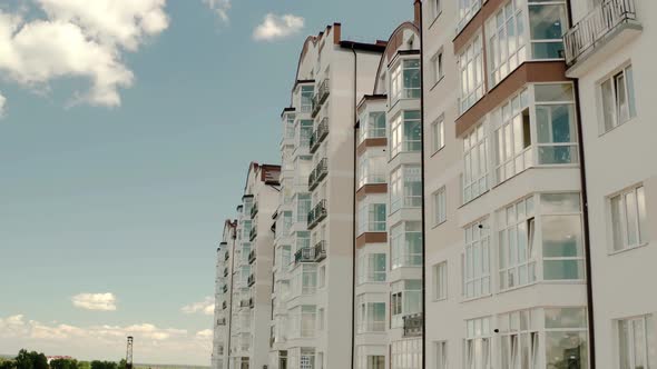 Aeria Drone Viewl of a Tall Residential Apartment Building with Many Windows and Balconies alt