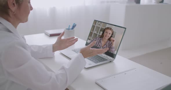 Young Woman Is Consulting Online with Her Gynecologist Doctor, Using Video Call By Internet at alt