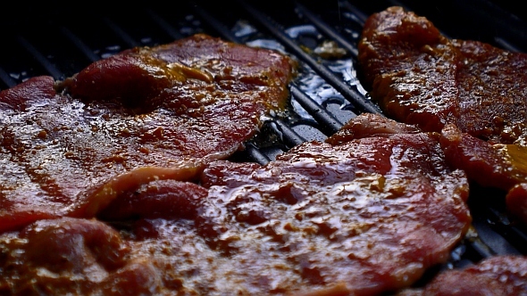 Beef Steaks Frying on a Grill Pan alt