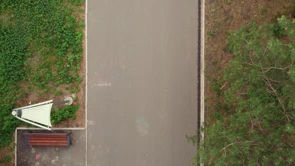 Aerial Dron Top Down View of Running Handsome Man in Morning Green Park alt