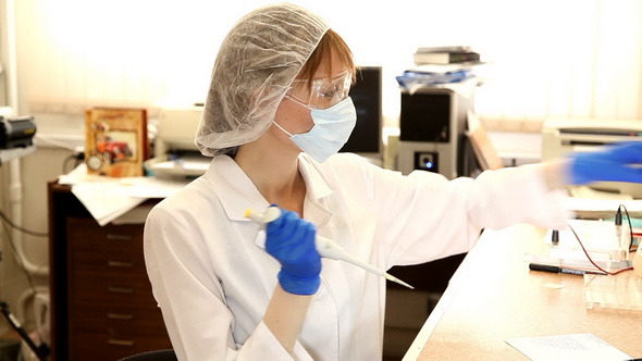 Woman scientist with gloves
