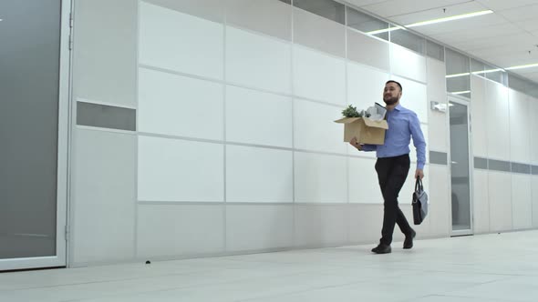 Asian Businessman Walking with Briefcase and Belongings to New Office alt
