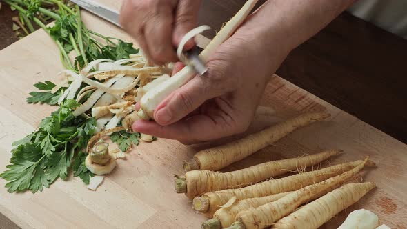 Slicing parsley root. Fresh parsley root on cutting board